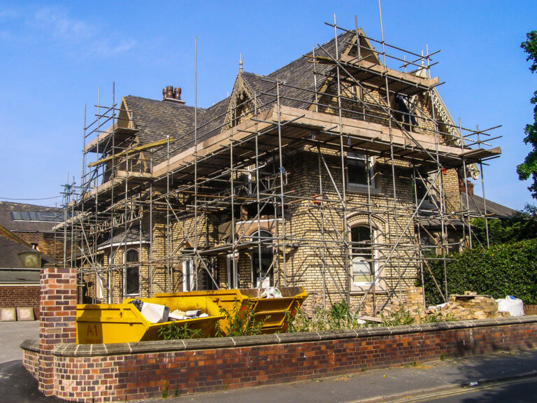 a house covered in scaffolding, representing home renovation insurance